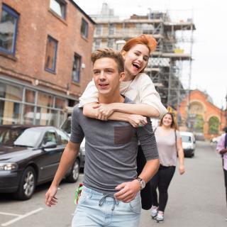 two students having fun in the street