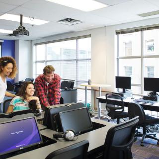 students looking at a screen in a classroom