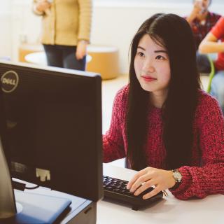 student in front of a computer