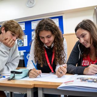 3 students studying in a classroom