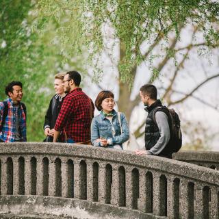 students talking together on a bridge