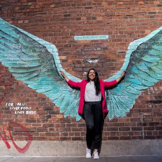 student with wings on a wall on the back
