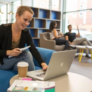 student smiling while working