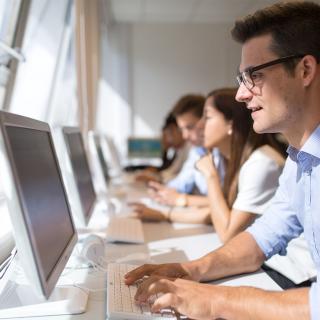 student looking at the screen of his computer