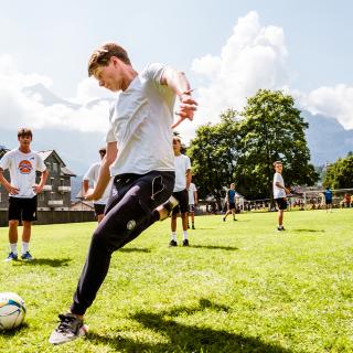 student playing football outside